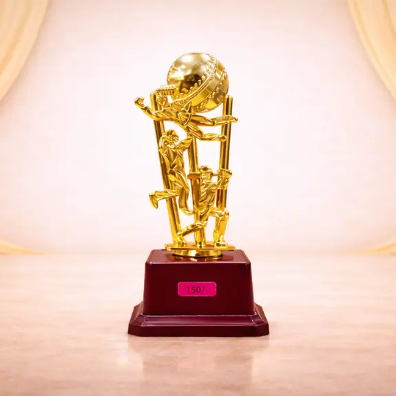 Gold cricket trophy on burgundy base